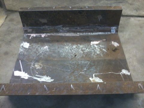 1995 Ford Bronco - This is a metal skid plate, likely for a vehicle, showing signs of fabrication and marking.
