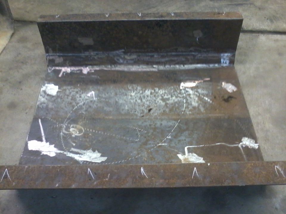 Metal skid plate with weld marks and chalk lines