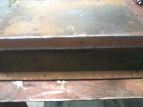 1995 Ford Bronco - Close-up of a heavily rusted metal component, likely a skid plate or similar undercarriage part.