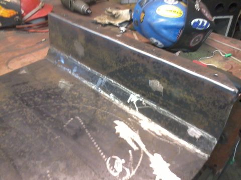 1995 Ford Bronco - A close-up view of a welded metal plate, showing signs of fabrication and wear.