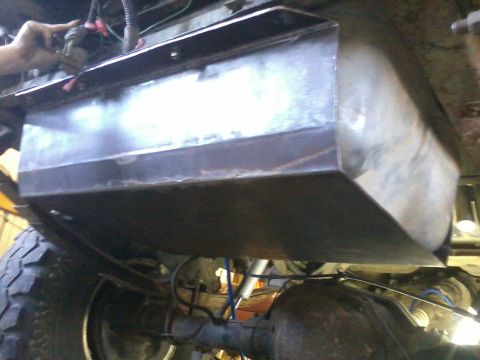1995 Ford Bronco - Custom skid plate installation on a vehicle's undercarriage, protecting the fuel tank and other components.