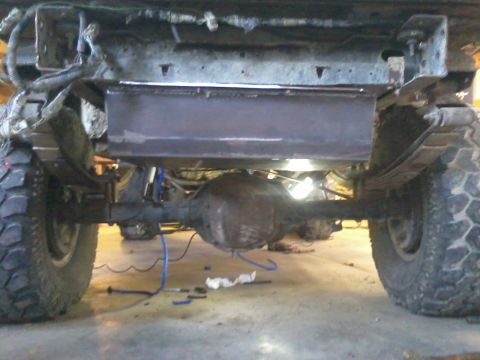 1995 Ford Bronco - This photo shows the rear axle and suspension components of a vehicle, with a custom skid plate recently fitted.