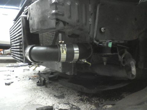 1987 Ford Bronco - Close-up view of intercooler piping and radiator assembly, likely during installation or repair.