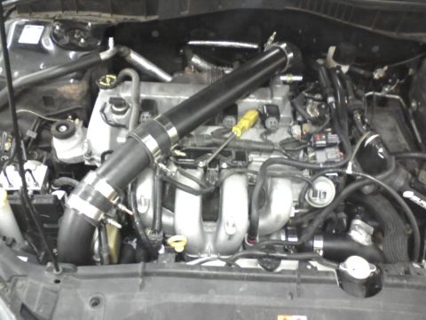 1987 Ford Bronco - Engine bay modifications are visible, including a large diameter intake pipe and aftermarket components.