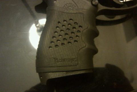 2000 Mercury Grand Marquis - The textured grip of a firearm is shown in detail, with some text visible on the side.