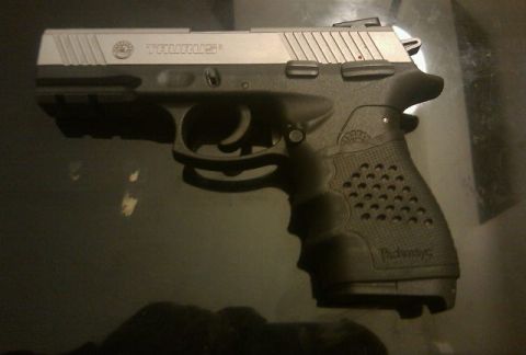 2000 Mercury Grand Marquis - A Taurus pistol is shown in a side profile against a dark background.