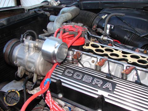 1973 Ford Ranchero - Close-up view of a vehicle engine, highlighting the "COBRA" branding on the valve cover.