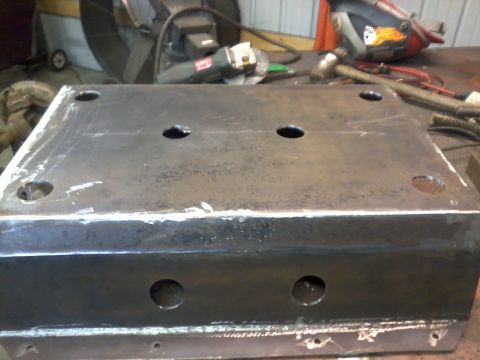 1995 Ford Bronco - This metal part, possibly a skid plate, features multiple holes for mounting or access.