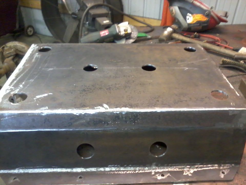 Metal skid plate with four large holes and four smaller corner holes