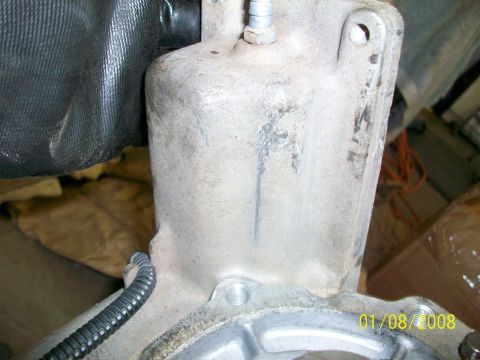 2000 Isuzu Vehicross - A close-up view of a vehicle's transmission housing, showing mechanical components and a date stamp.