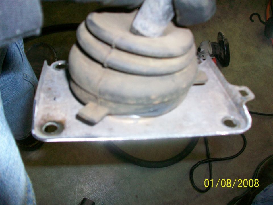 Gear shifter boot and metal mounting plate, dusty, with a date stamp of 01/08/2008