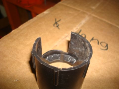 1995 Ford Bronco - Close-up of a black plastic automotive part on a cardboard surface with handwritten markings.