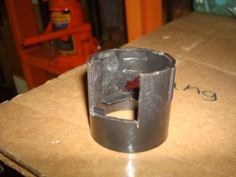 1995 Ford Bronco - A close-up view of a damaged black plastic component with visible red material within its housing.