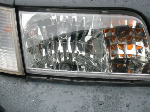 1998 Ford Crown Victoria - Close-up of the headlight assembly on a 1998 Ford Crown Victoria.