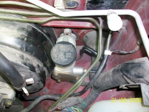 2000 Isuzu Vehicross - Close-up view of engine bay components including brake fluid reservoir and various hoses.