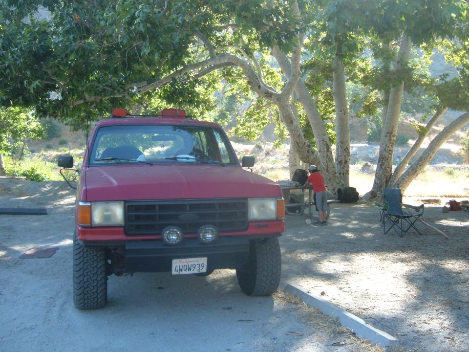 1988 Ford Bronco parked at a campsite