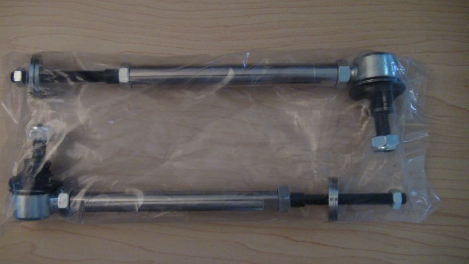 Pair of silver tie rods in plastic packaging