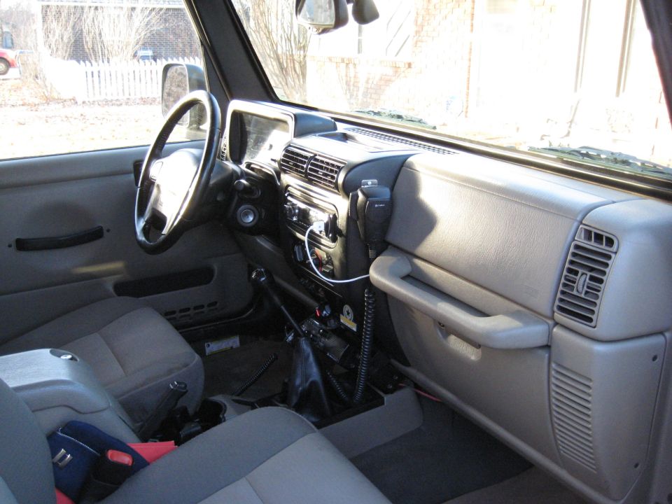 Gray interior of a 2005 Jeep Wrangler, showing the dashboard, steering wheel, and seats
