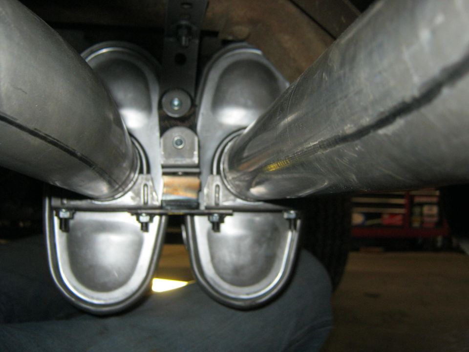 Dual exhaust tips mounted under a vehicle