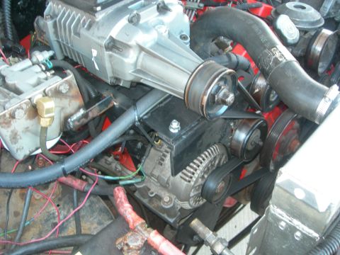 1984 Ford Bronco - Close-up of an engine bay showing a supercharger installation with various hoses and wiring.