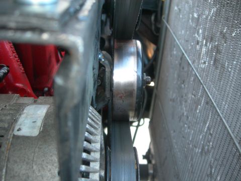 1984 Ford Bronco - Close-up view of an engine's belt and pulley system, likely part of a supercharger installation.