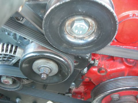 1984 Ford Bronco - A detailed view of the serpentine belt system and associated pulleys on a vehicle's engine.