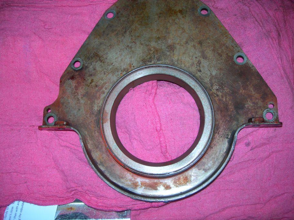 Engine timing cover with a large central opening and mounting holes