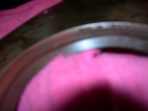 1984 Ford Bronco - Close-up of a wheel rim with pink fabric covering part of it.