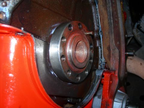 1984 Ford Bronco - Close-up of an engine's crankshaft flange, showing bolted connections and gasket residue.