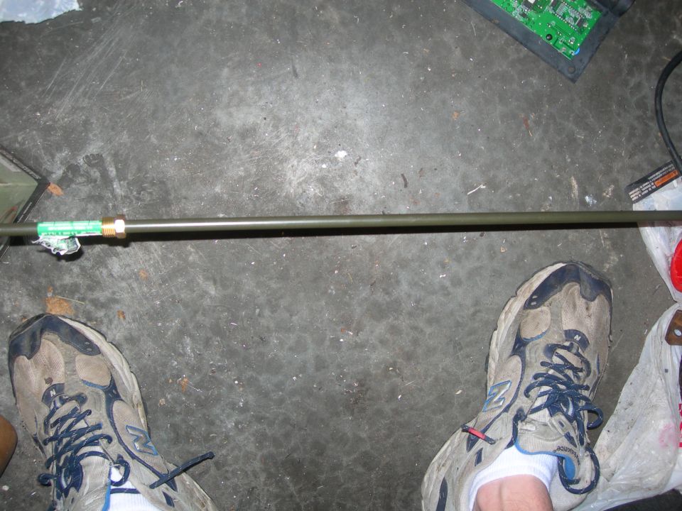 metal rod with brass fitting and green label