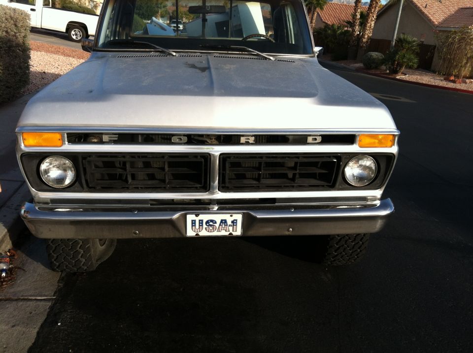 Silver 1977 Ford F-150 front view with black grille and USA1 license plate