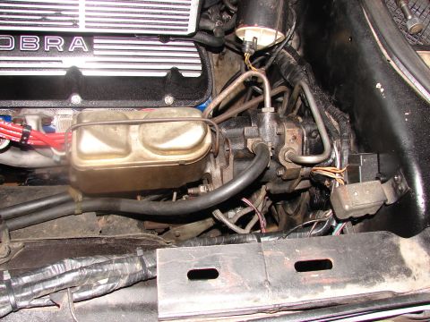 1973 Ford Ranchero - Close-up view of the engine bay of a 1973 Ford Ranchero, showing the "COBRA" valve cover and brake system components.