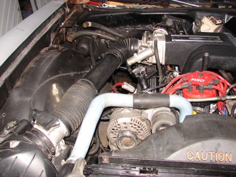 1973 Ford Ranchero - Close-up of an engine bay an MSD ignition system and a prominent "CAUTION" warning label on the fan shroud.