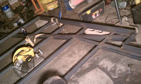1990 Ford Bronco - Metal frame construction in progress, with a chop saw ready for use.