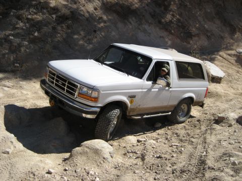 1996 Ford Bronco - White 1996 Ford Bronco tackling a challenging rocky trail.