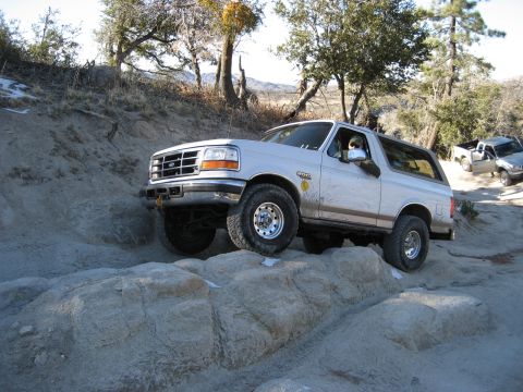 1996 Ford Bronco - Ford Bronco navigating a challenging rocky off-road course.