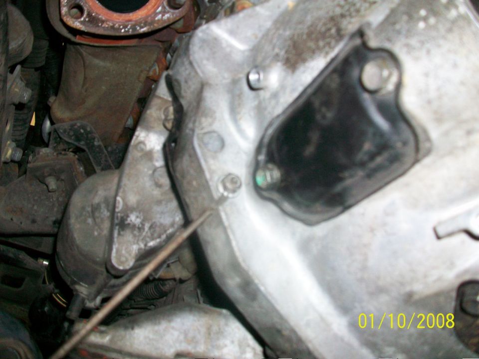 Engine block with black cover and metal components, date stamp 01/10/2008