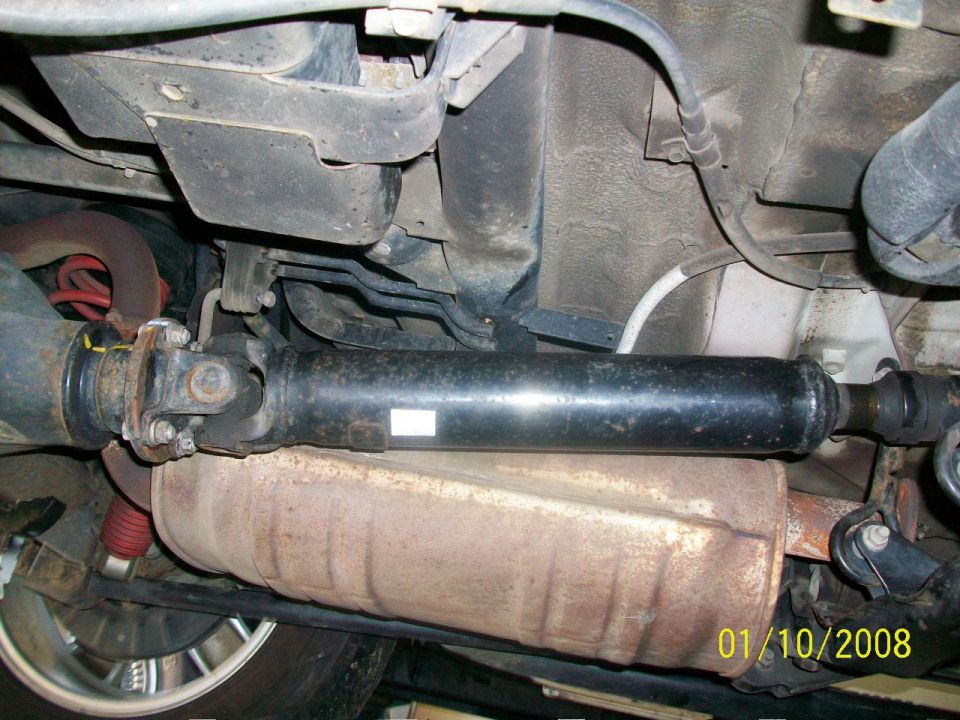 Underside view of drivetrain and exhaust system with visible date stamp