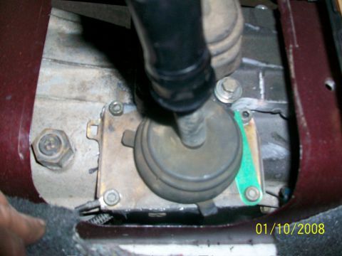 2000 Isuzu Vehicross - Close-up view of a vehicle's gear shifter mechanism, showing mechanical parts and a rubber boot.
