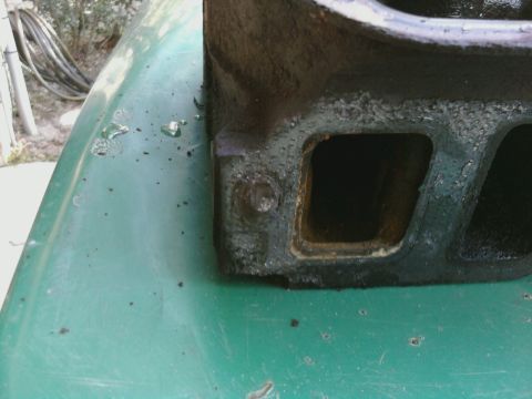 1995 Ford Bronco - Cast iron engine intake manifold part shown in detail on a green surface.