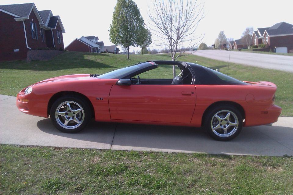 Red 1999 Chevrolet Camaro parked on a driveway