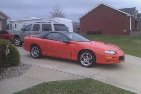 1999 Chevrolet Camaro - This 1999 Chevrolet Camaro is seen in a driveway with other vehicles.
