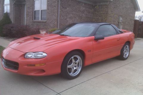1999 Chevrolet Camaro - This red Chevrolet Camaro SS features a black t-top roof and aftermarket wheels.