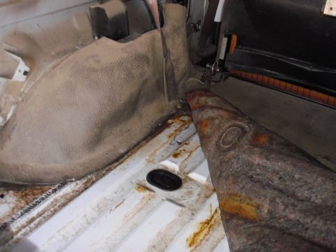 1993 Ford Bronco - The interior cargo area shows signs of wear and a large, rusty metal object is present.