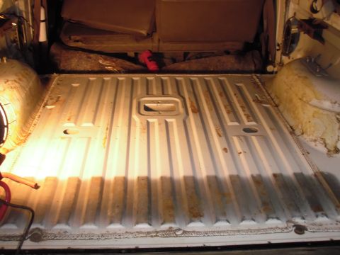 1993 Ford Bronco - Interior view of a vehicle's cargo area, showing the ribbed metal floor and a folded rear seat.