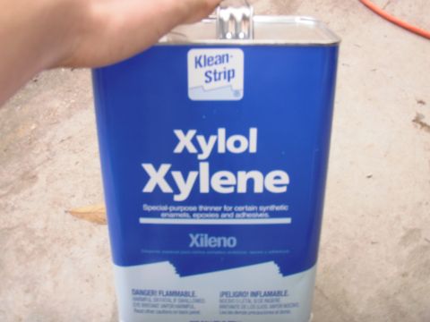 1993 Ford Bronco - A Klean-Strip Xylol Xylene can is held by a hand, with a Supermotors.net logo visible at the bottom right.