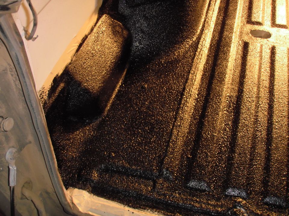 Black textured truck bed liner with ribbed floor, viewed from above