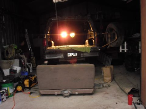 1993 Ford Bronco - The rear of a 1992 Ford Bronco is visible with its tailgate open and brake lights on.