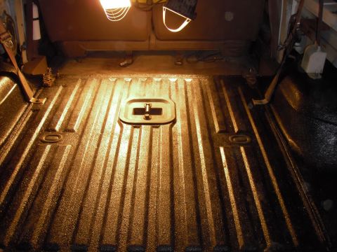 1993 Ford Bronco - The interior of a vehicle's cargo area shows a textured bed liner and seat upholstery.