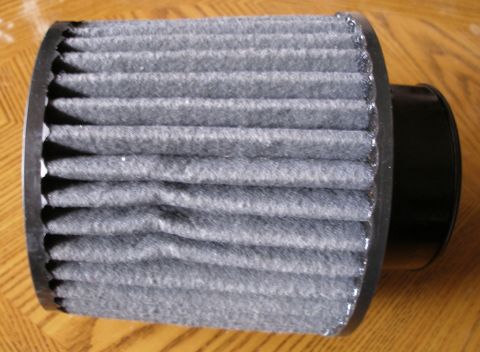 2010 Hyundai Genesis - A close-up view of a gray pleated air filter with black end caps, showing its construction.